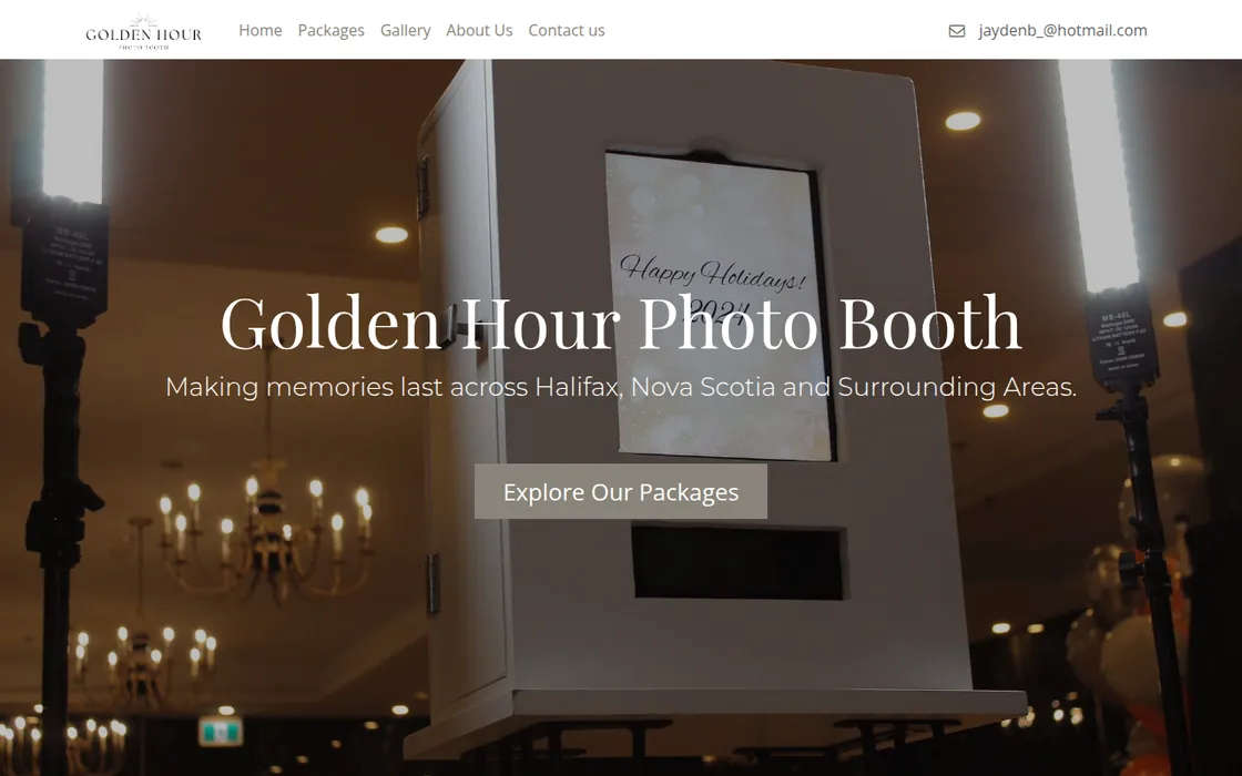 Screenshot of the Golden Hour Photo Booth homepage: a white serif headline reading Golden Hour Photo Booth over a warm photo of a photo booth and a chandelier inside an event venue.