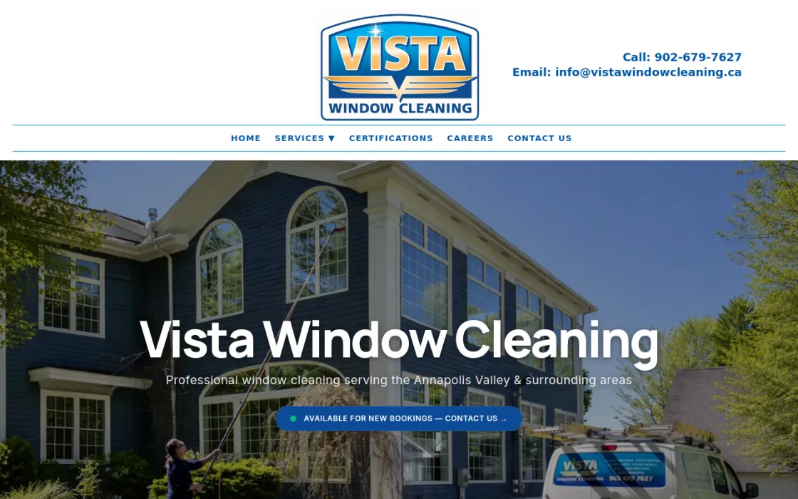 Screenshot of the Vista Window Cleaning homepage: a bold white headline over a photo of a crew cleaning a blue home.