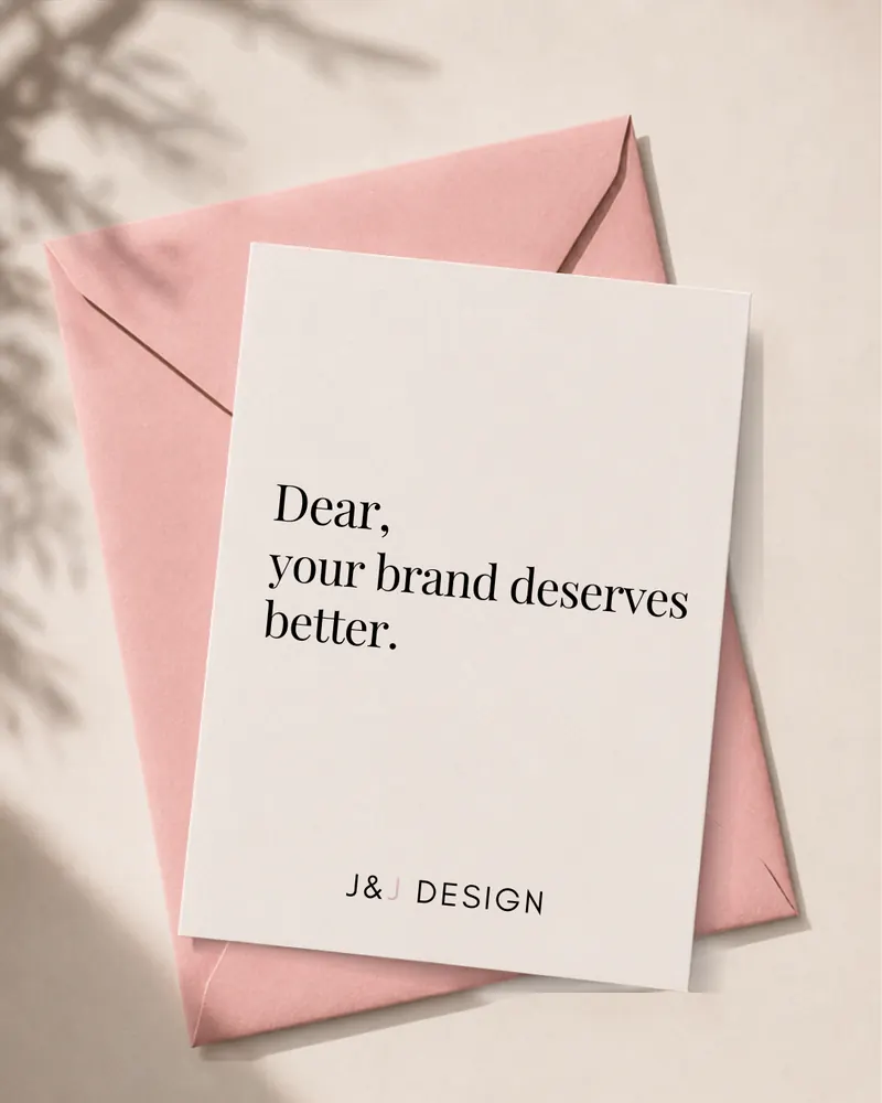 A J&J Design note card on a pink envelope reading: Dear, your brand deserves better.
