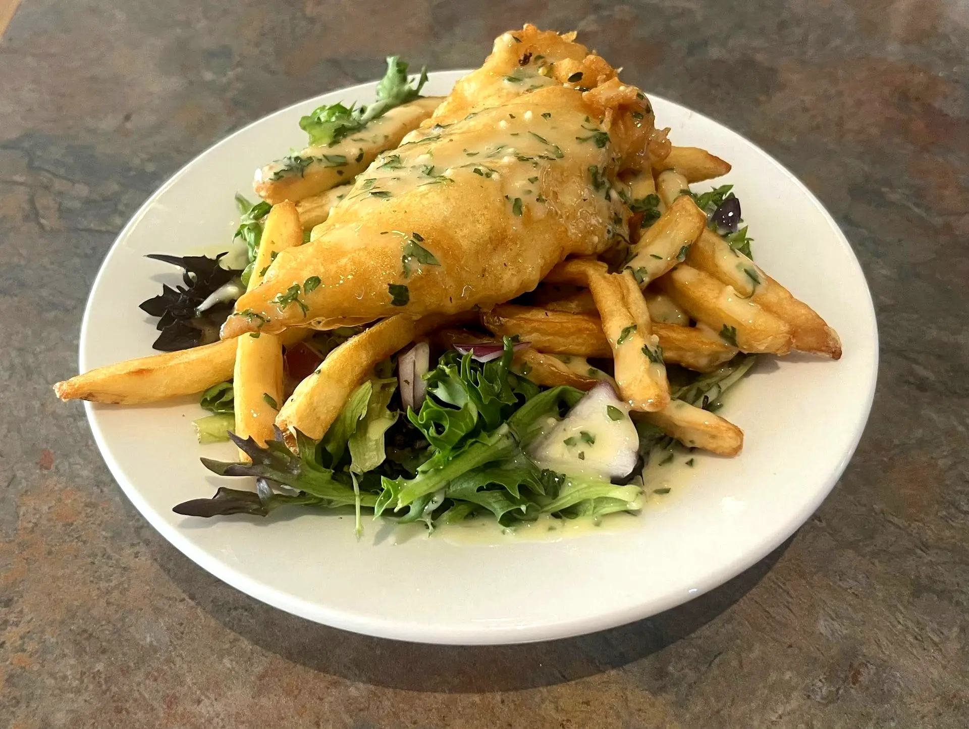Fish on greens with fries